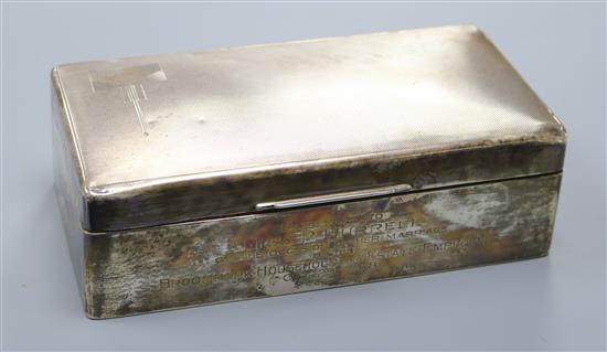 A 1930s Art Deco engine turned silver cigarette box, with presentation inscription, 17.9cm.